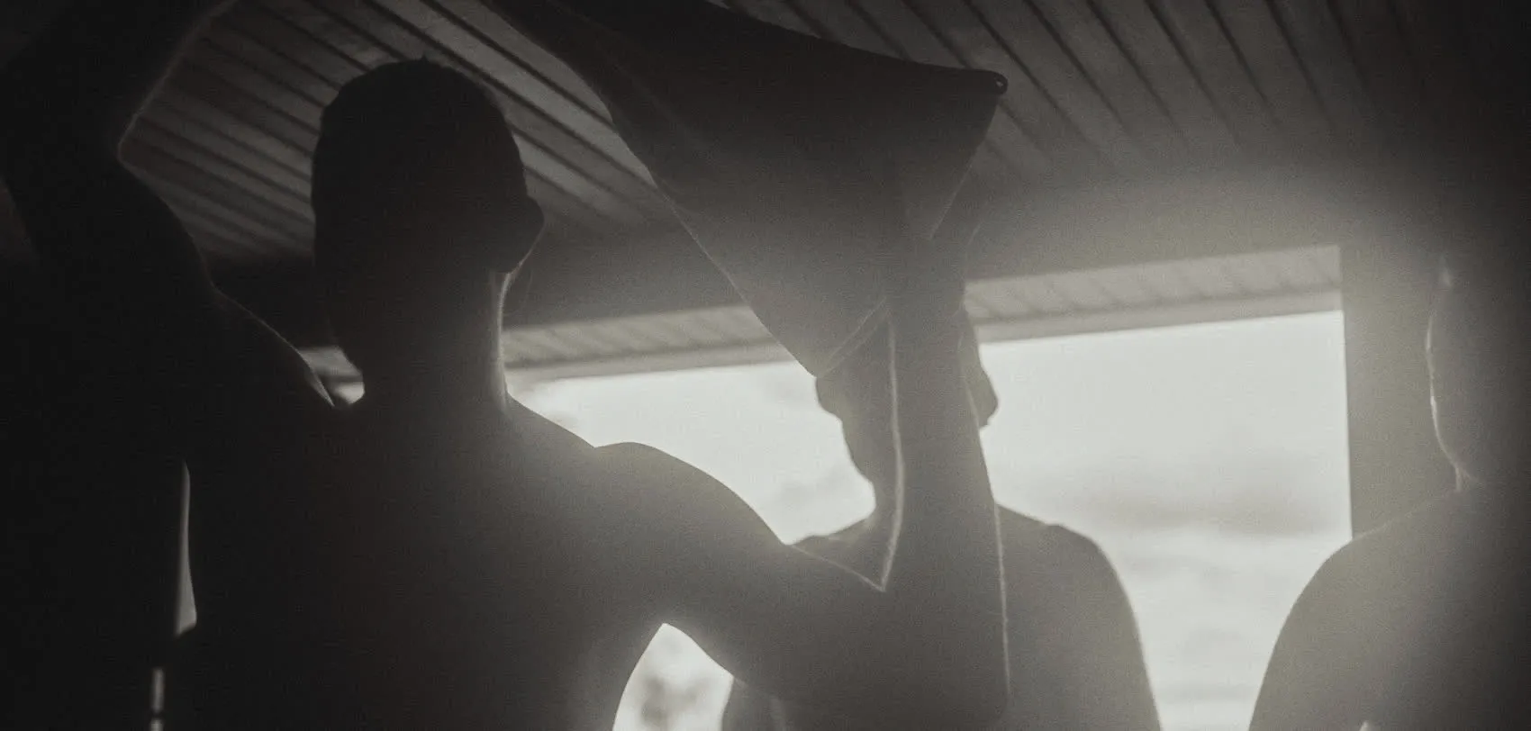 Bathers raising towels in the sauna during a Birthday Suit session at Blue Mountains Sauna