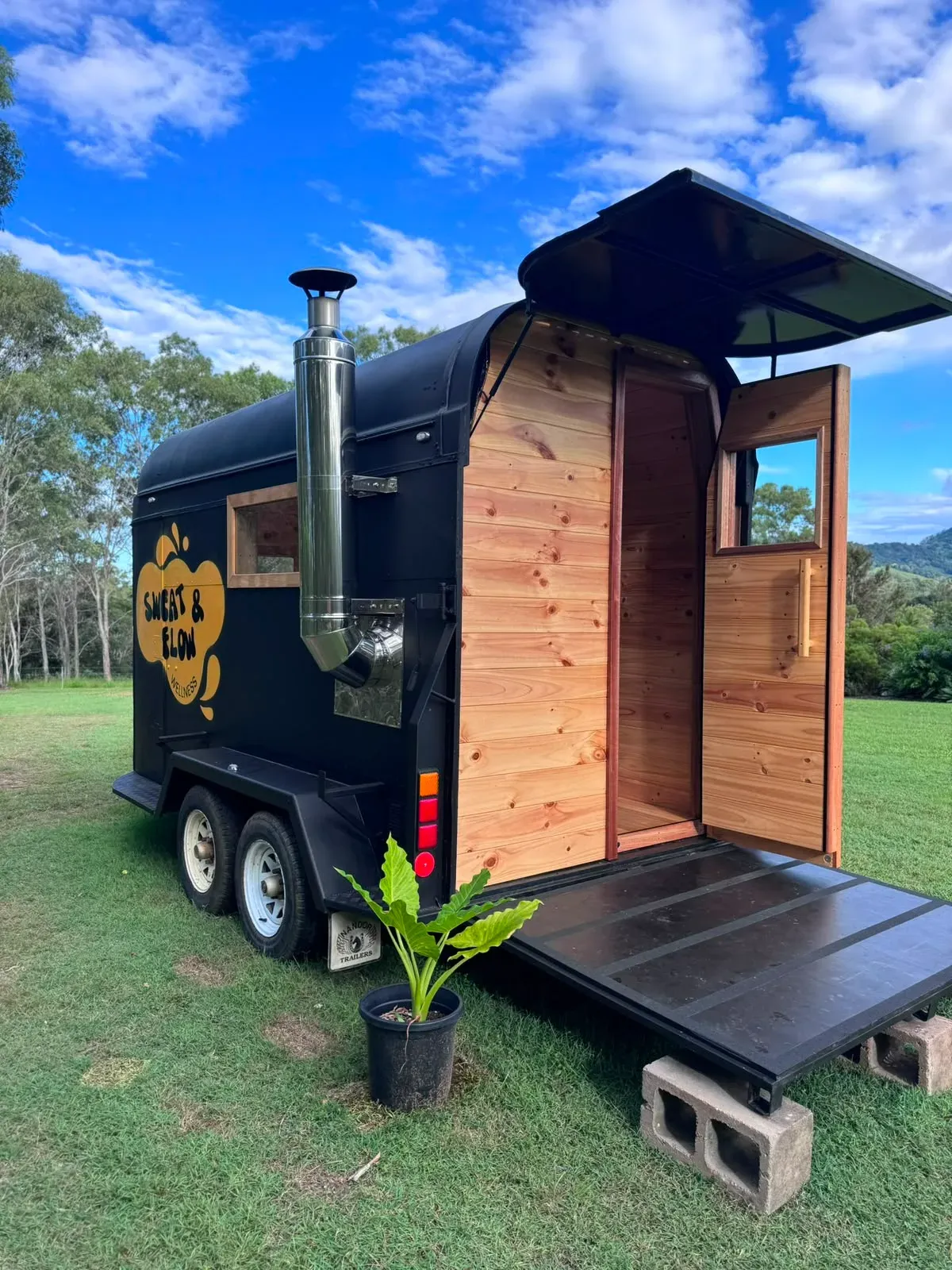 The Sweat & Flow mobile wood-fired sauna with its door open
