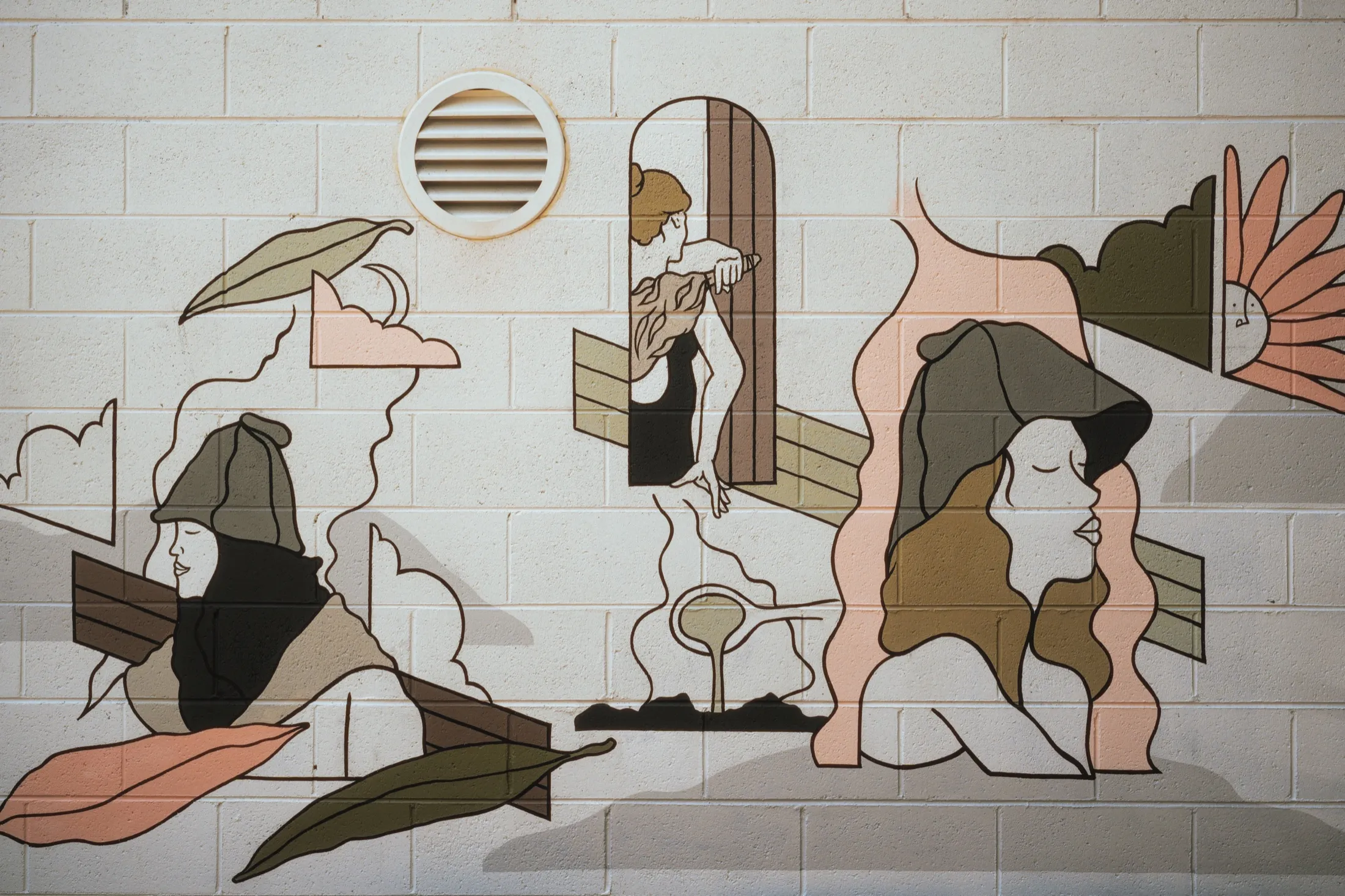 The hand-painted bathers mural in the outdoor rest area