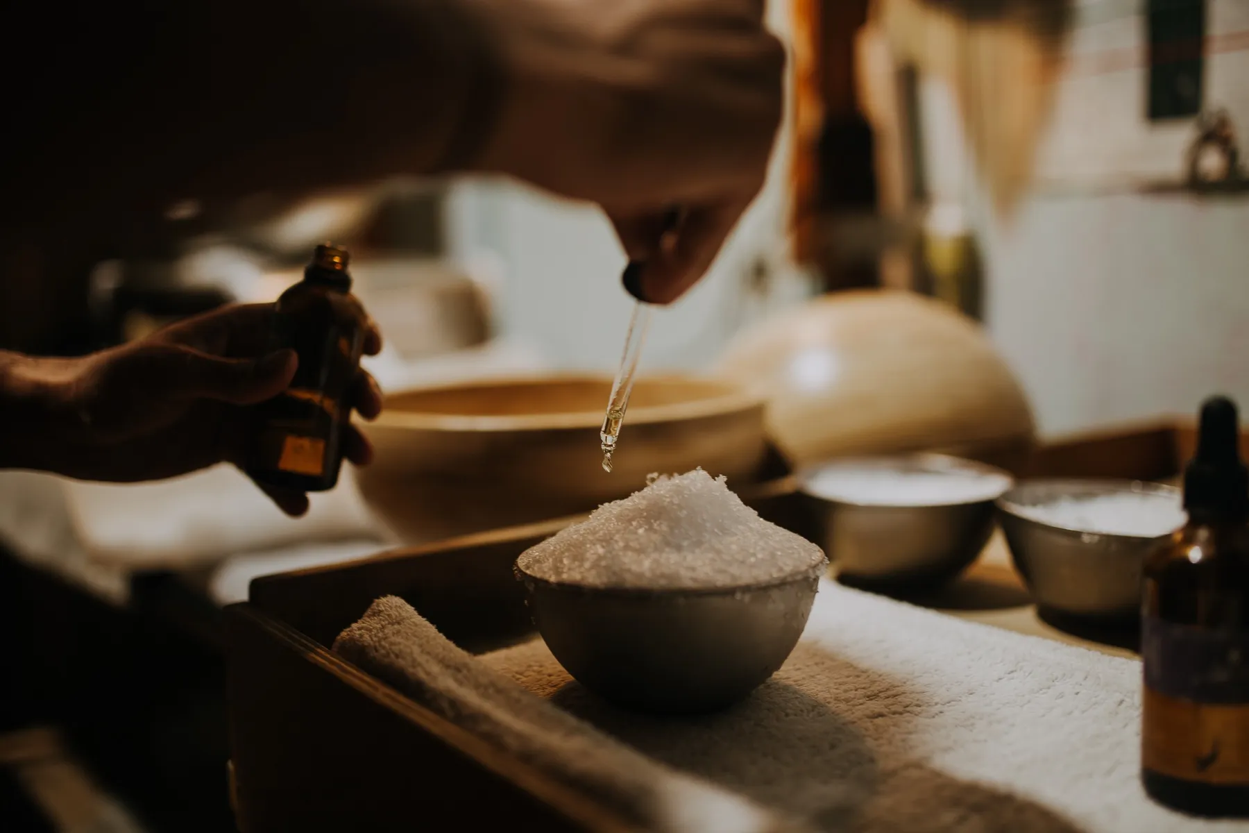 Essential oils dropped into a bowl of crushed ice