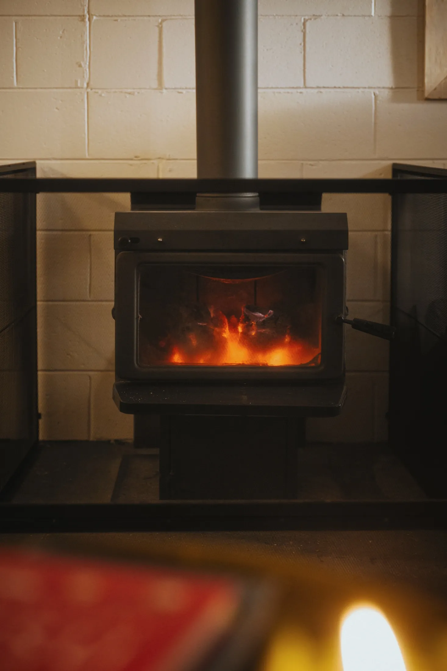The wood-burner glowing in the indoor rest area