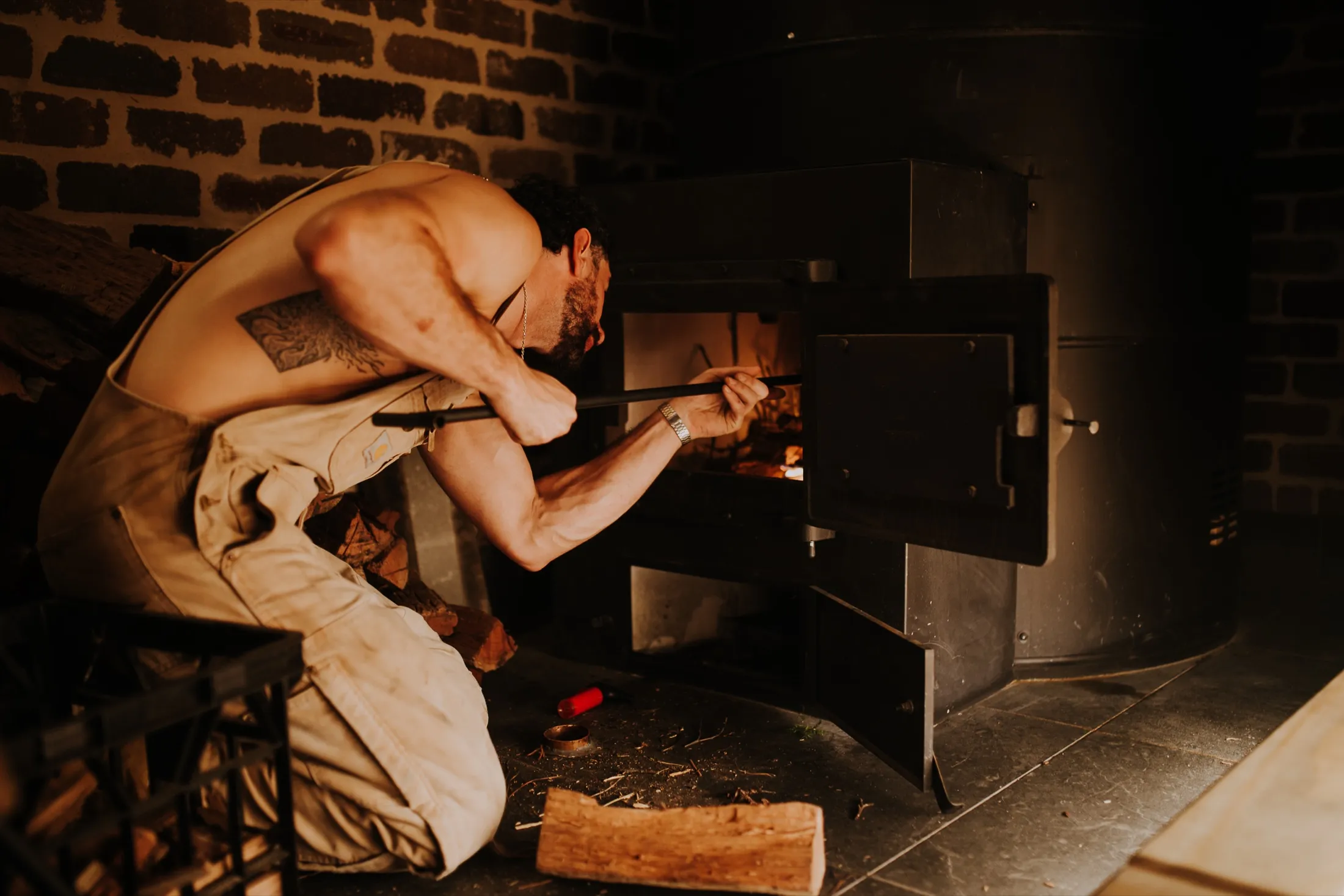 Tending the wood-fired stove that heats the Savusauna