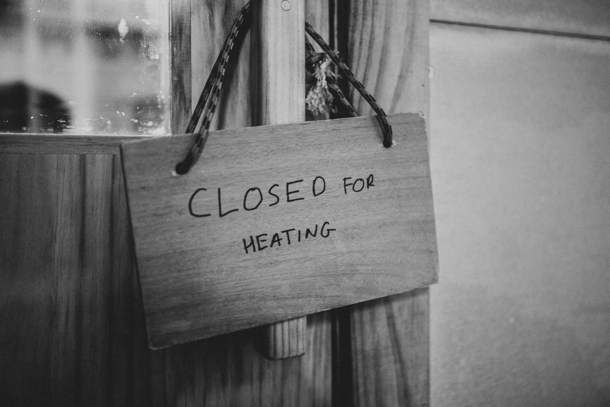 A hand-lettered 'Closed for heating' sign on the savusauna door