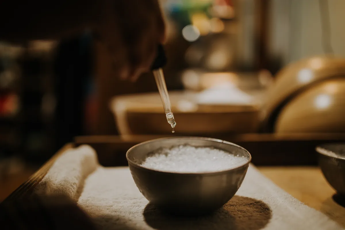 Dropping essential oils onto ice for an Aufguss ceremony at Blue Mountains Sauna