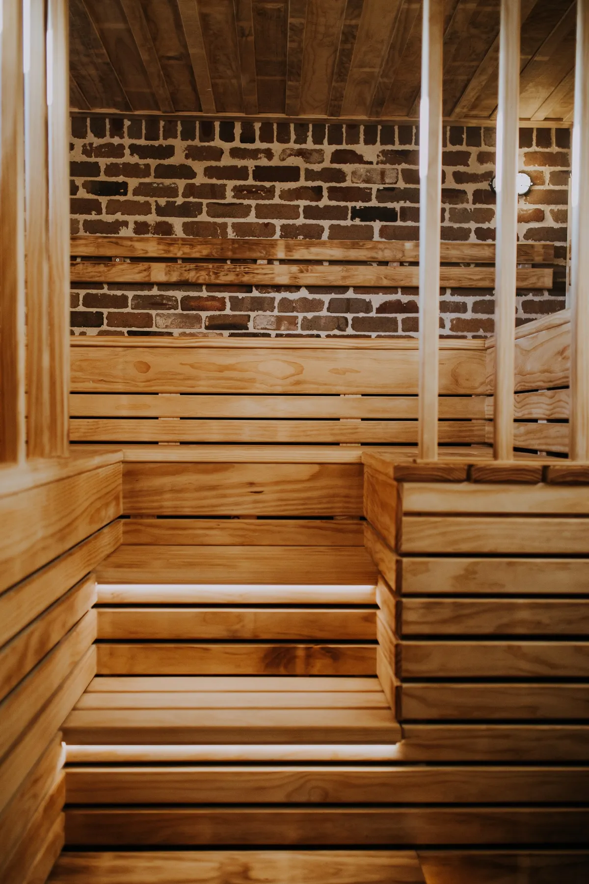 The timber benches and brick interior of the sauna at Blue Mountains Sauna
