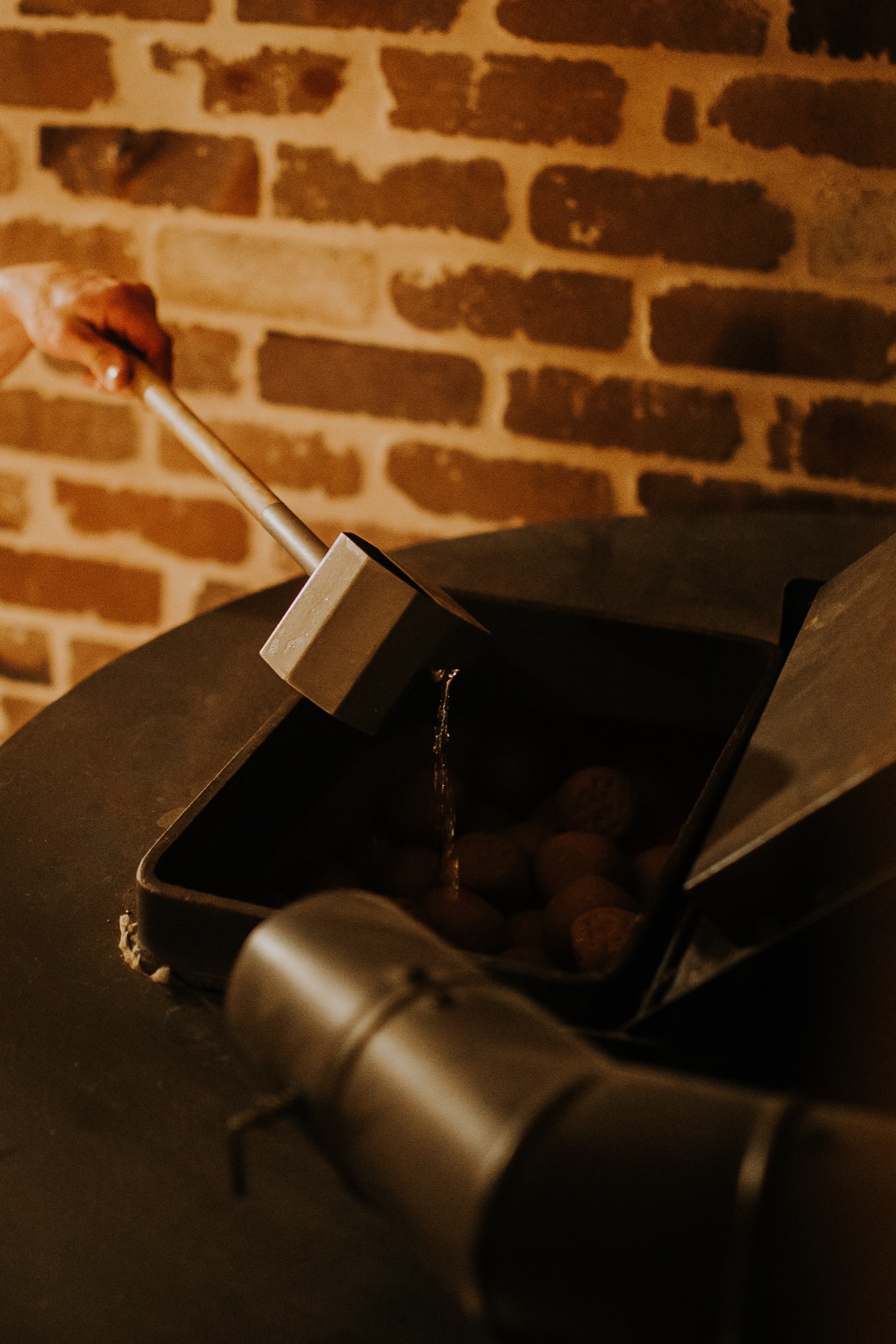 Pouring water onto the smoke sauna stones