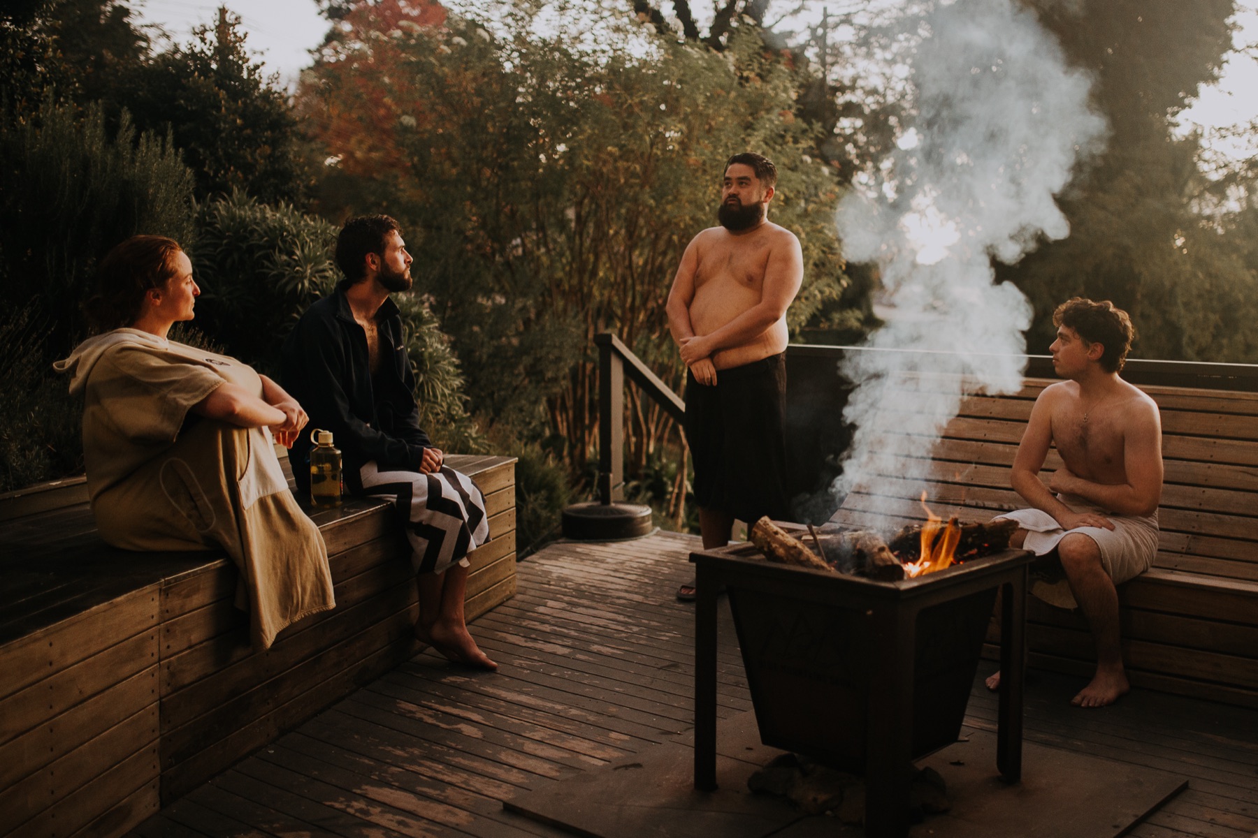 Guests relaxing around the outdoor fire pit