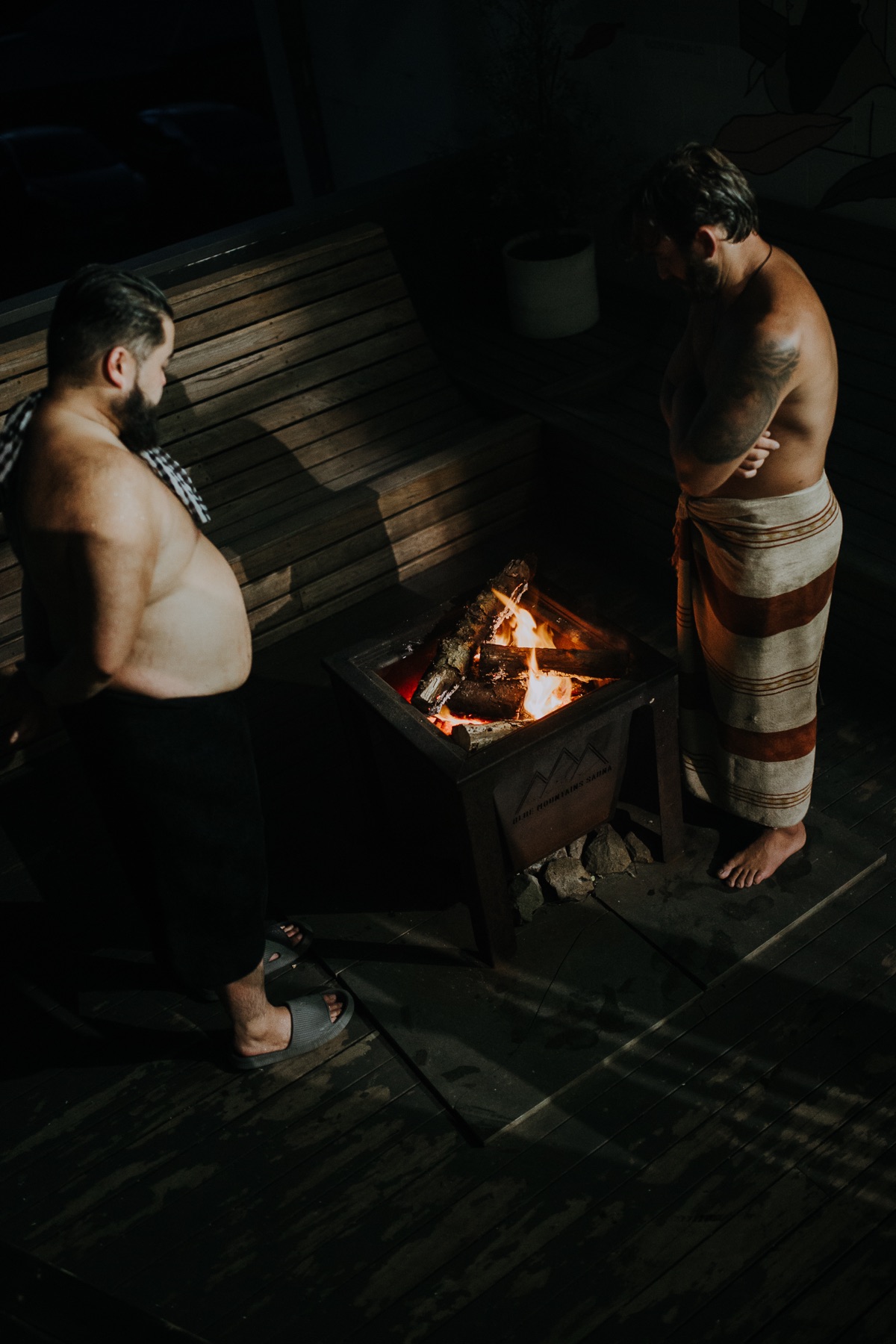 Two bathers by the outdoor fire pit
