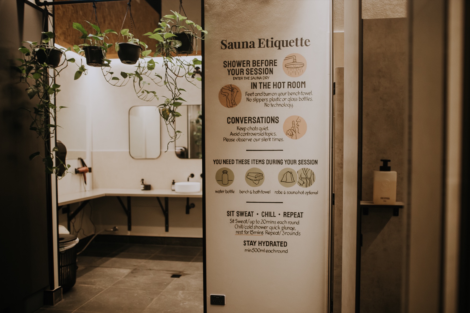 Sauna etiquette sign by the washroom basins