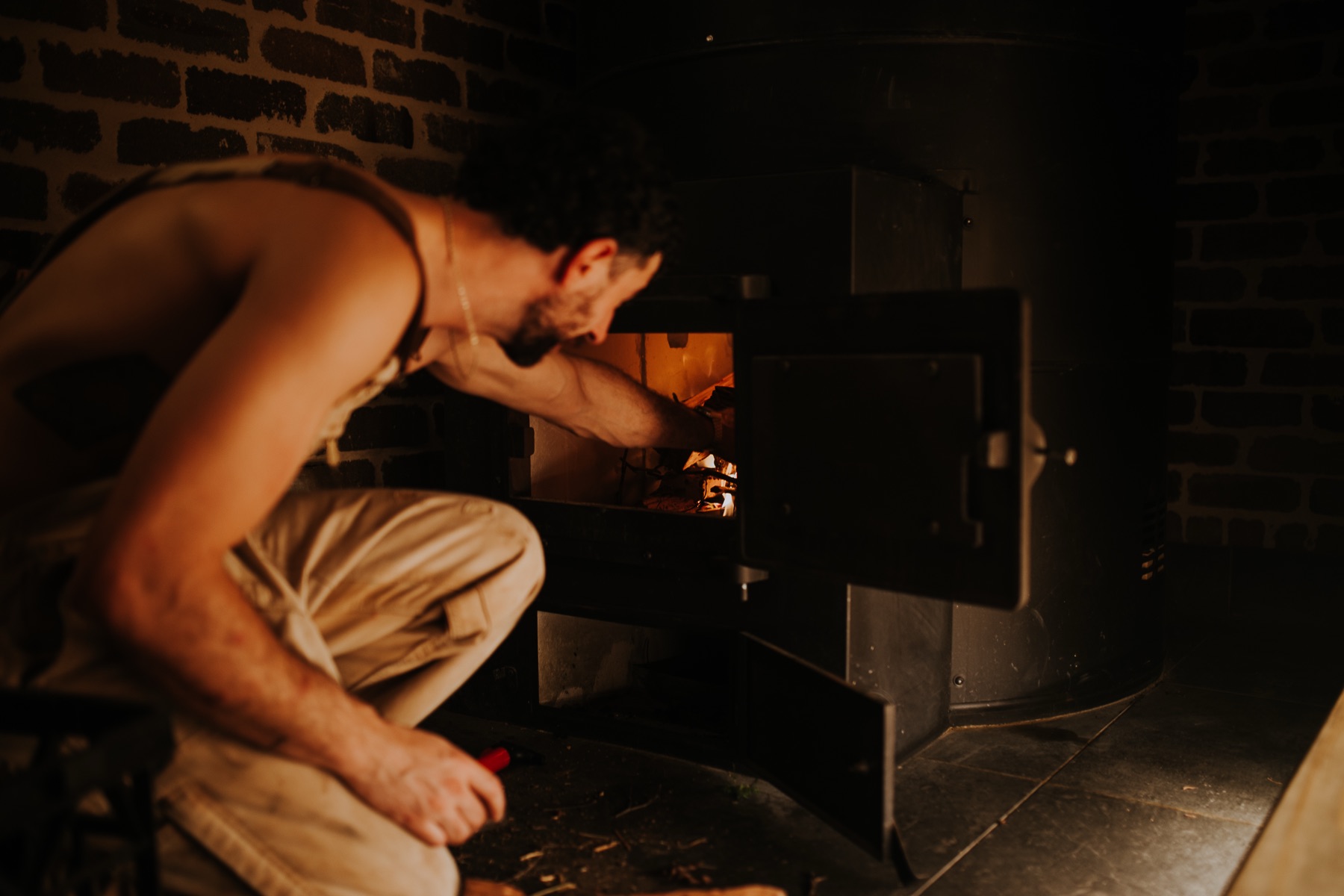 Feeding logs into the glowing stove