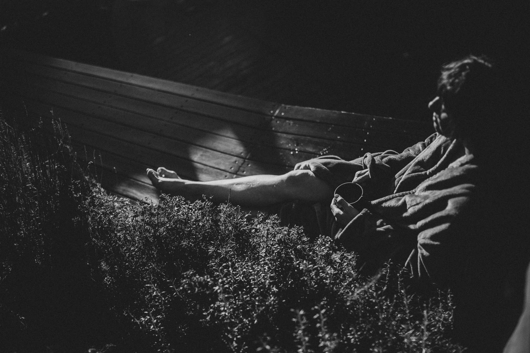 Bather reclining on the deck at dusk